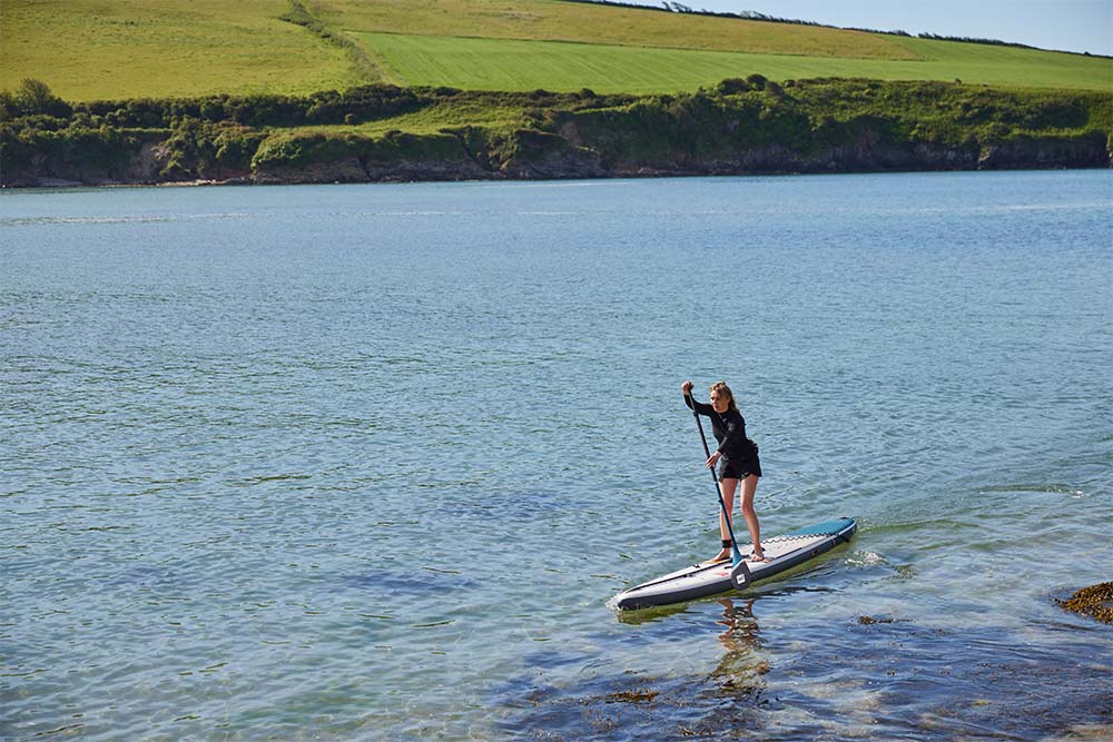Woman paddling Red Original SUP in the sea
