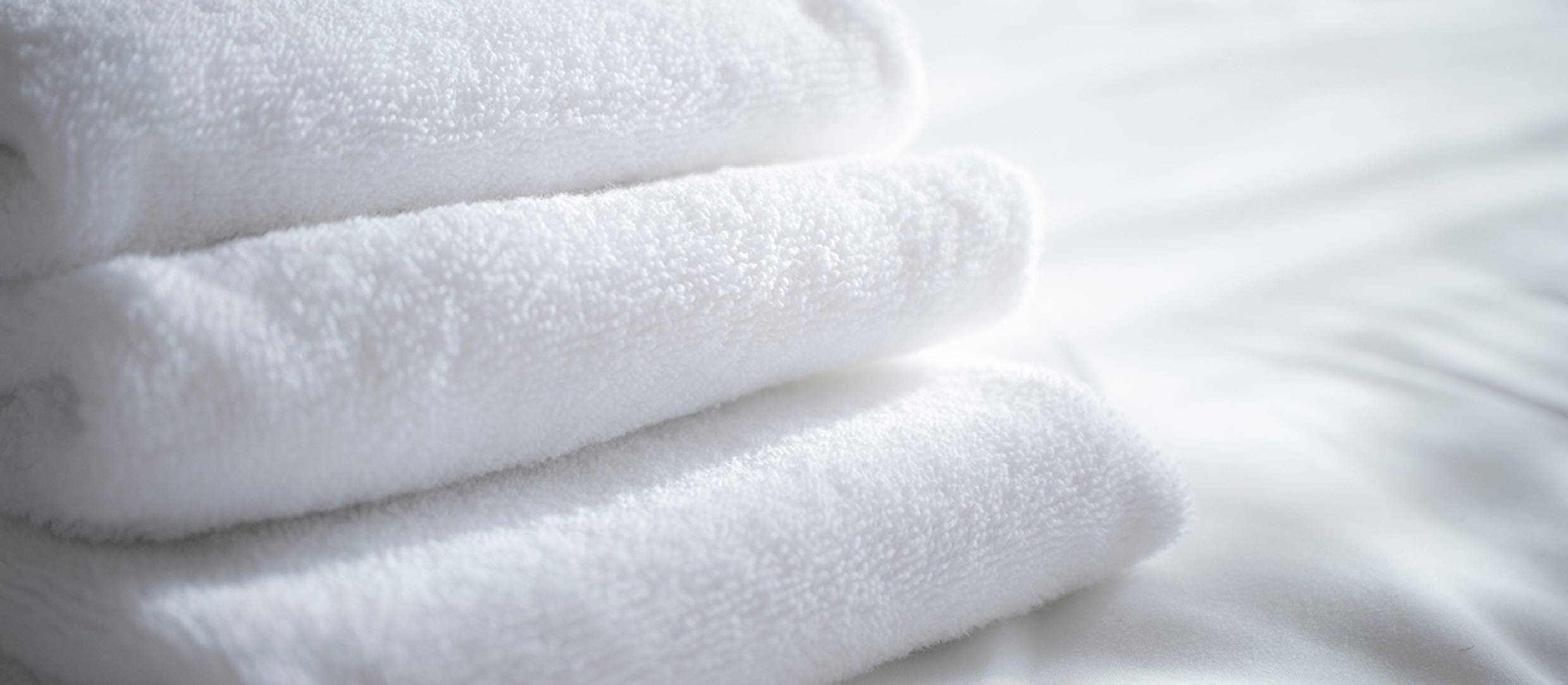 Stack of freshly laundered white spa towels
