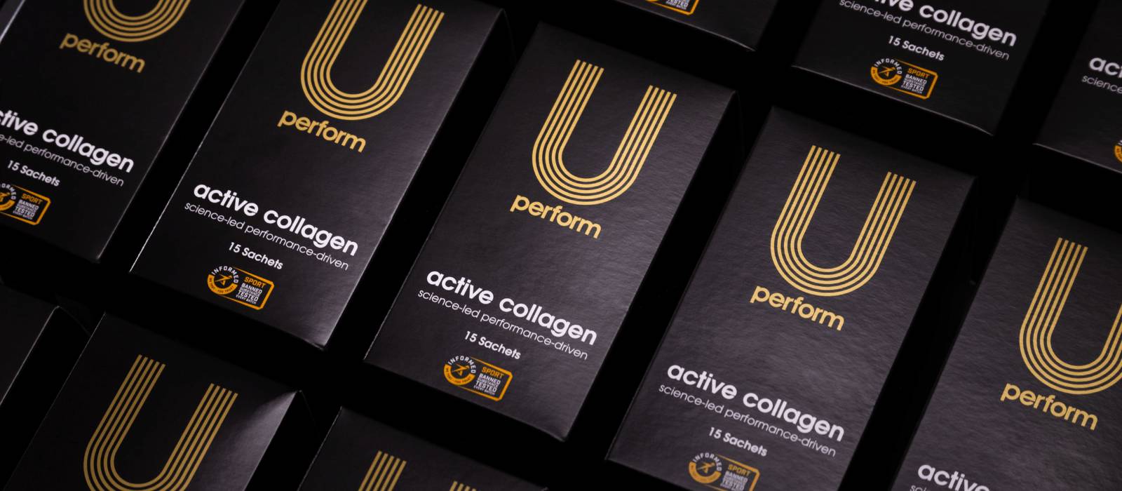 U Perform Active Collagen boxes lined up on a black background
