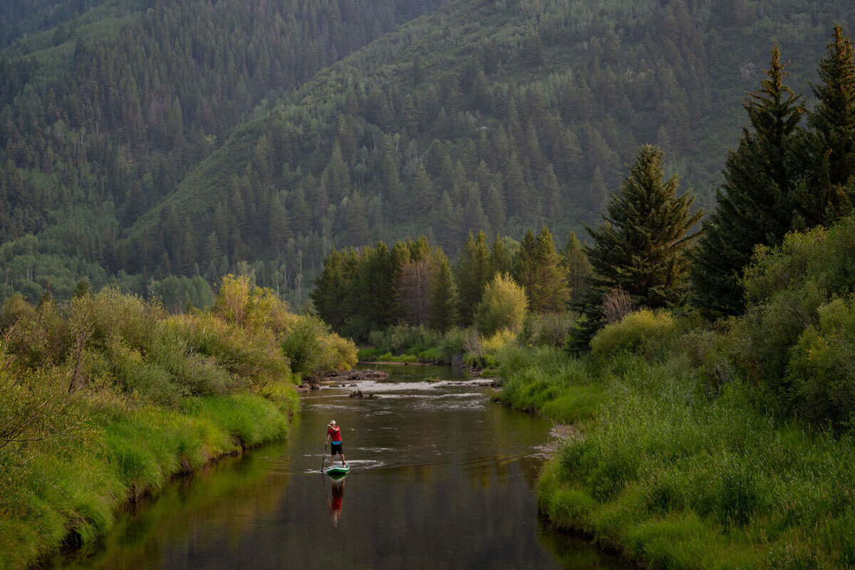 Paddleboarder on a flowing river