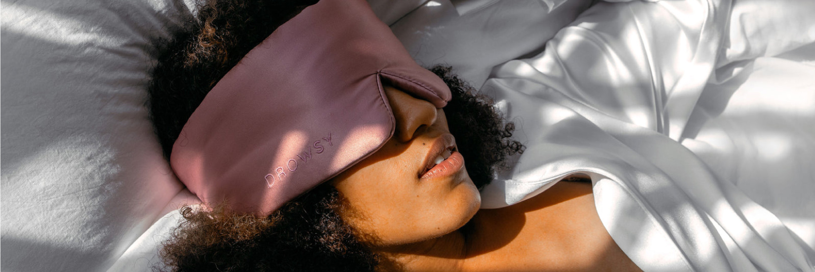 Woman Sleeping On White Sheets With Drowsy Silk Eye Mask