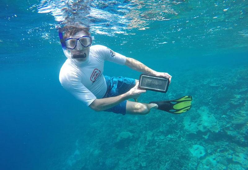 Man underwater with a waterproof pouch