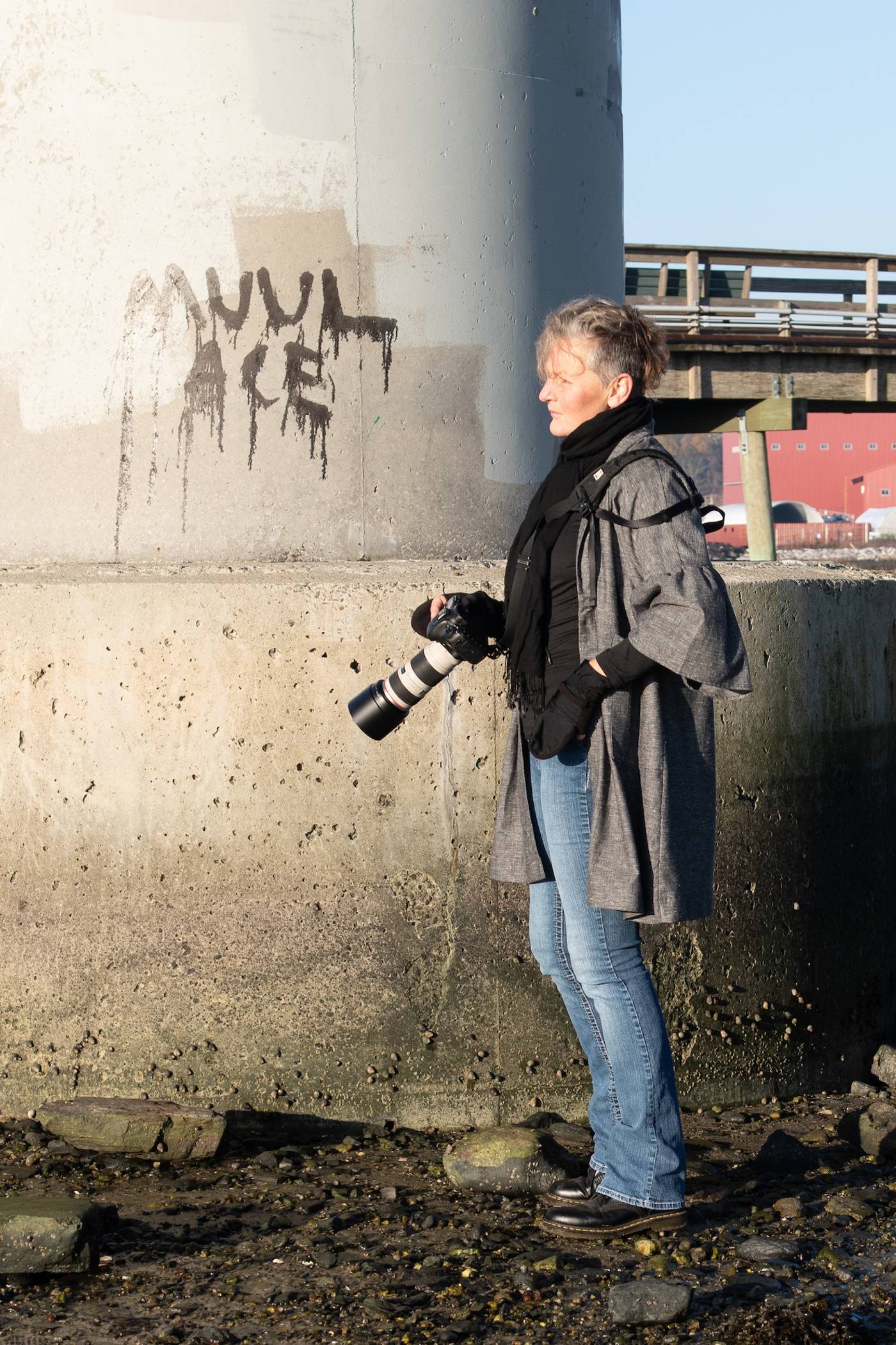 Joanne standing next to graffiti, modeling the brush duster