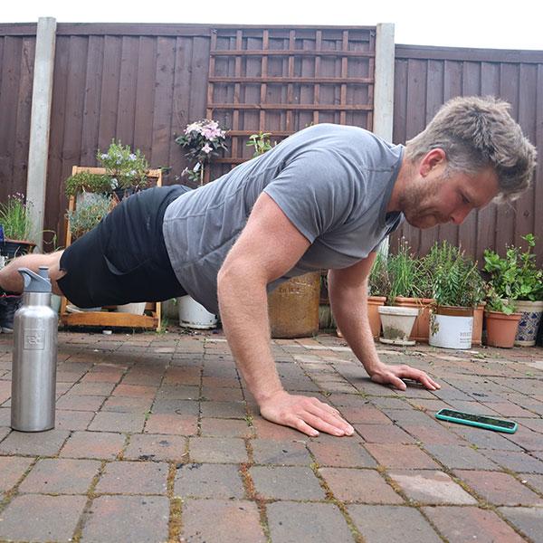 Man doing a Push Up in his garden 