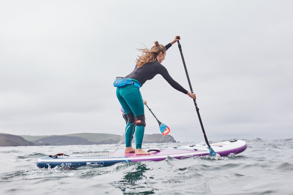 Woman Paddle Boarding On A Choppy Sea