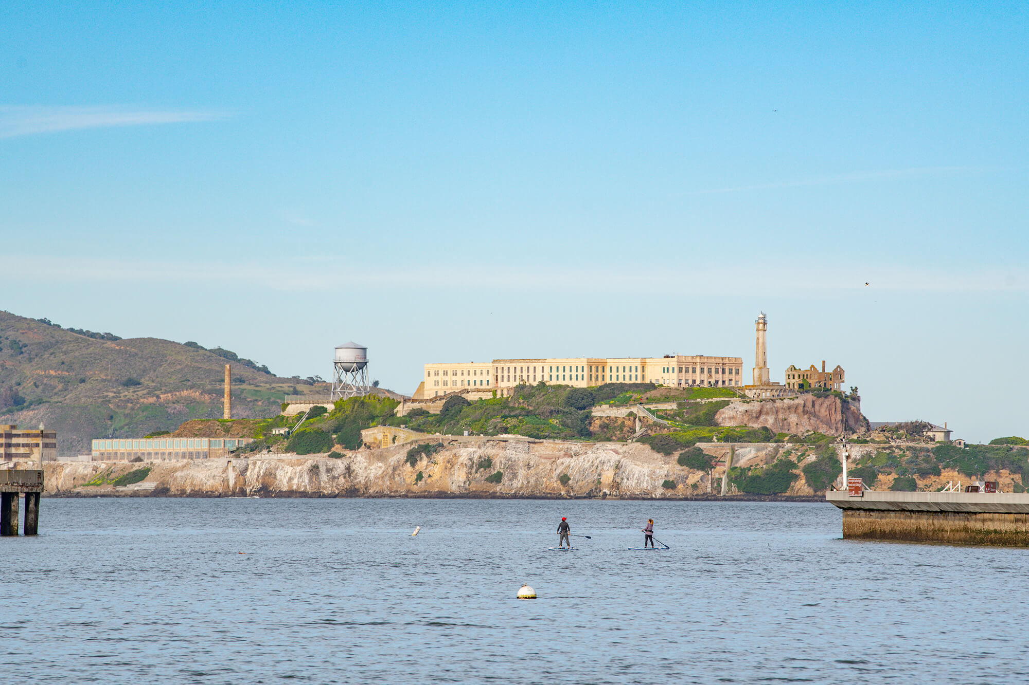 2 Paddle Boarders With Alcatraz Prison In The Background