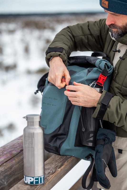 Man with a waterproof backpack and 2 insulated stainless steel water bottles