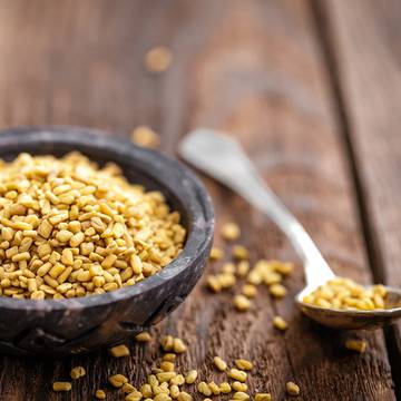 Dried Fenugreek Seeds in a Bowl and Spoon