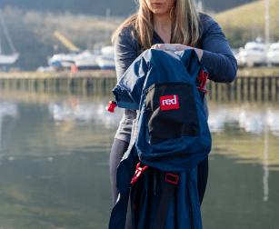 woman using red original stash bag in navy
