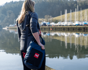 woman wearing red original stash bag in navy