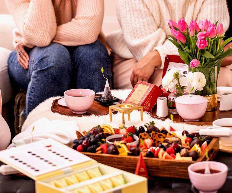 Gathering around a Charcuterie Board with cups of tea and tulips