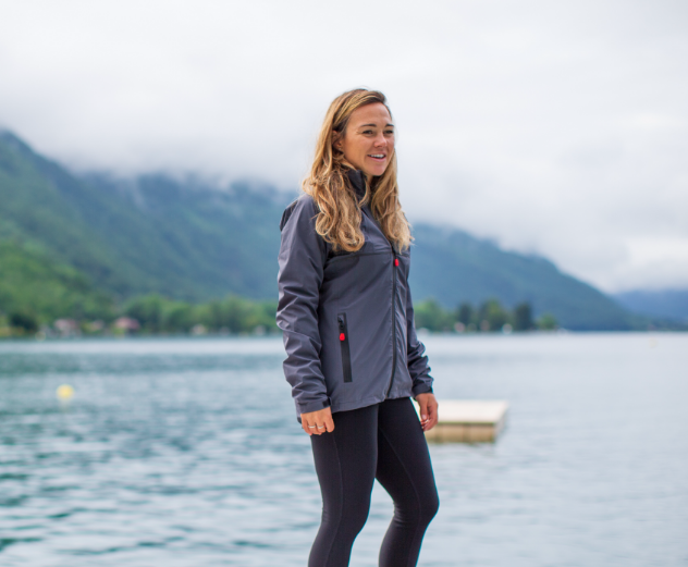 Woman wearing Red Original active jacket by a lake