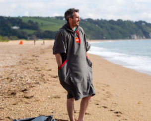 Man on beach wearing Red Original changing robe