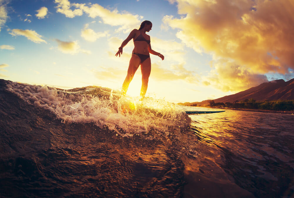 Woman Surfing At Sunset