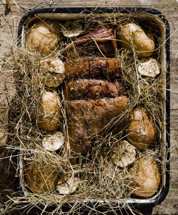 Roast Mutton Cooked in Hay with Baked Potatoes, Garlic & Green Herb Sauce  Pipers Farm Recipe  Sustainable Seasonal Food  Pipers Farm Cookbook