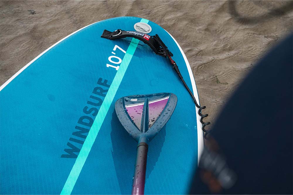Red Original hybrid adjustable paddle placed on top of SUP

