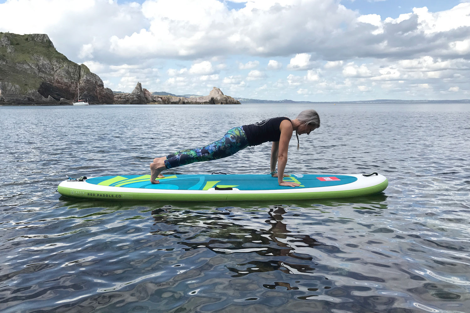 woman doing a plank on her paddleboard