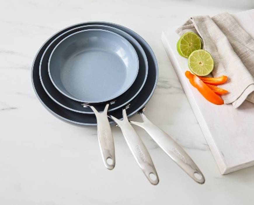 GreenPan Valencia Pro 3-Piece frypan set stacked on kitchen counter. 