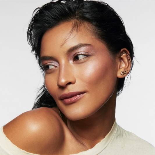 A model wears soft glam makeup created with Milk Makeup products