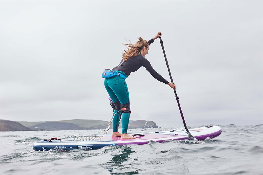 Woman paddling Red Original SUP in the sea