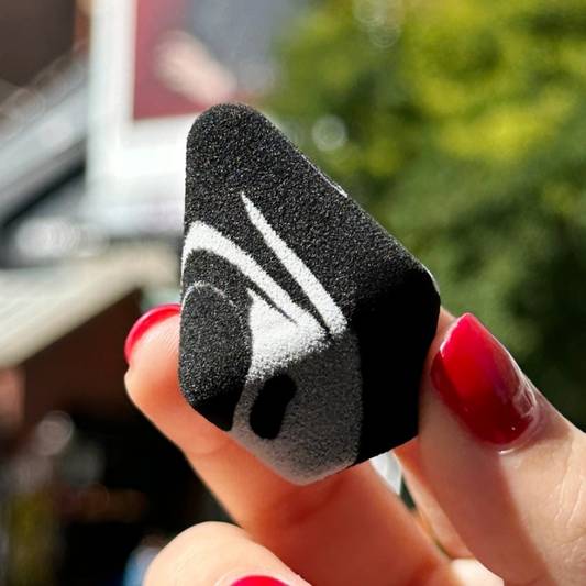 Hand holding Milk Makeup Prism Sponge