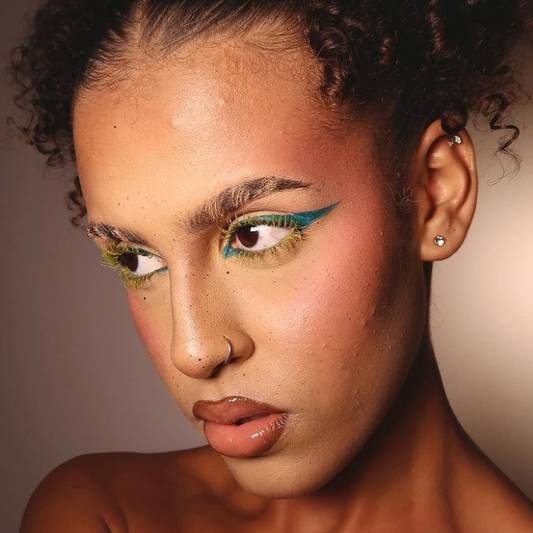 Model wears a colorful makeup look for holiday makeup inspiration