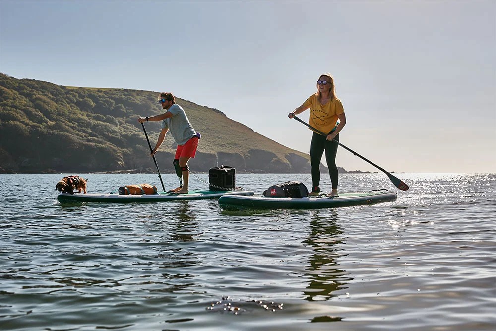 Man and woman paddle boarding in a lake
