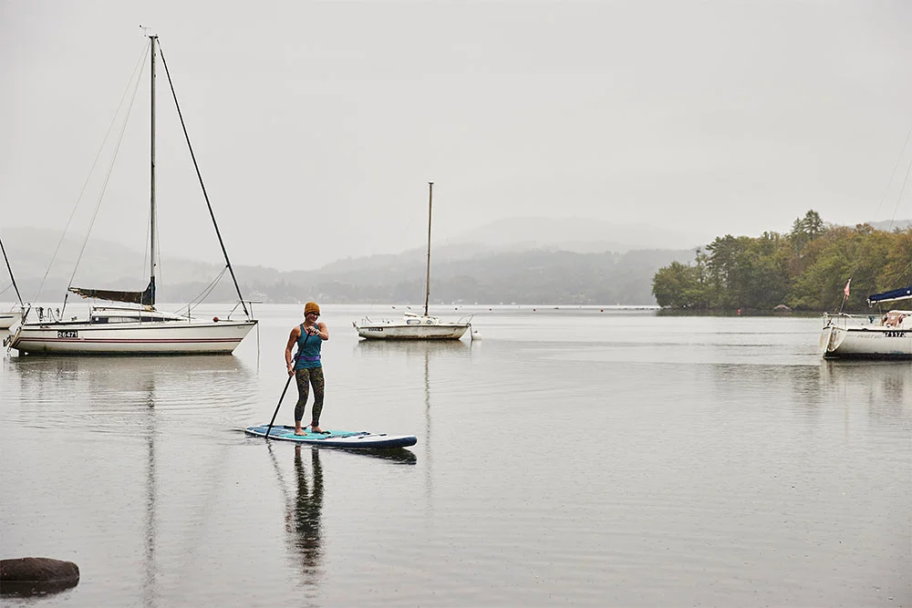 Woman paddle boarding in a lake
