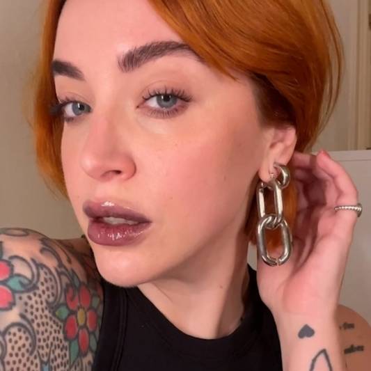 Milk Makeup Director of Artistry Sara Wren wears a sheer black lip gloss look.