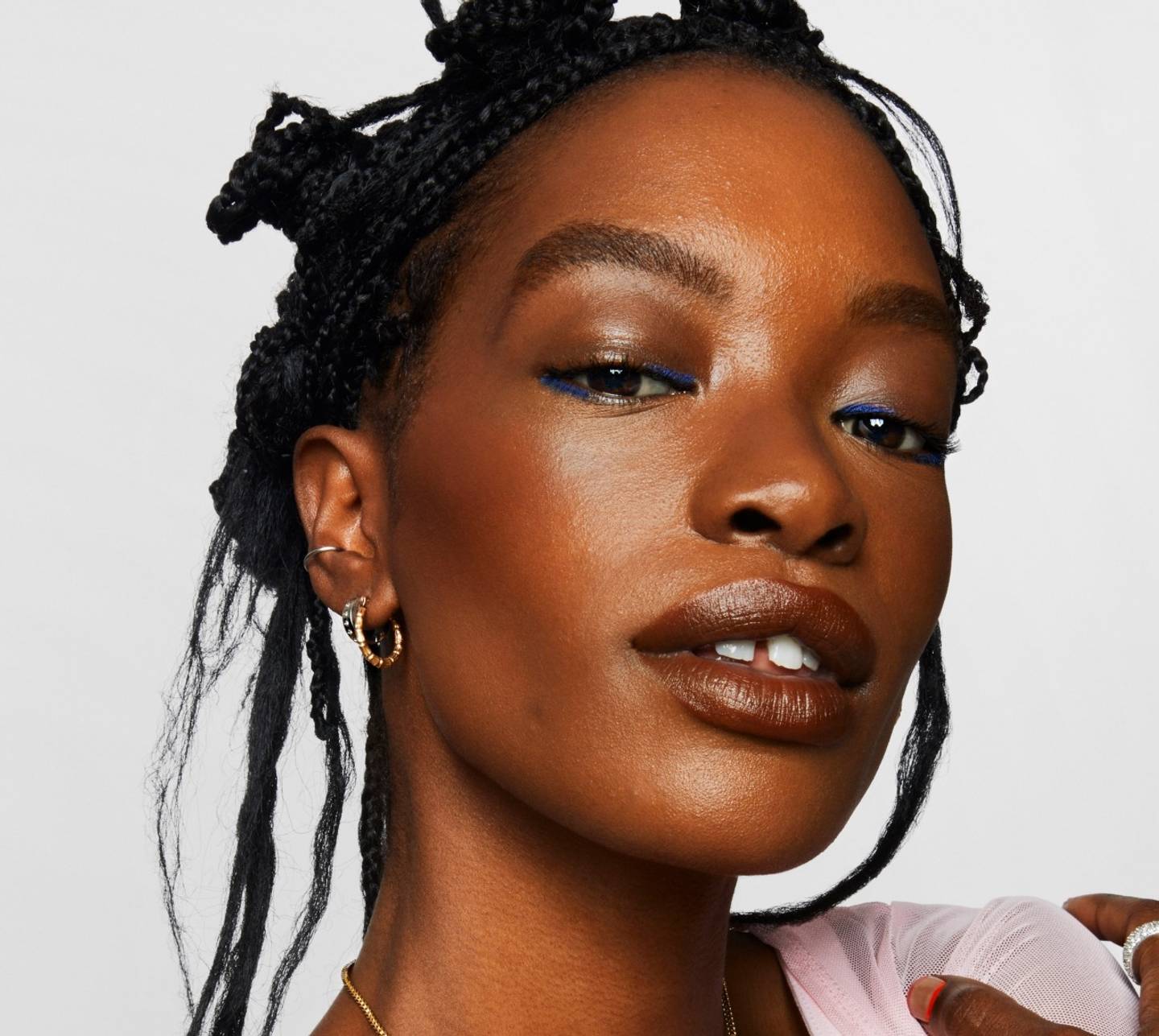 Model wears a full face of Milk Makeup products including Matte Bronzer against a white background