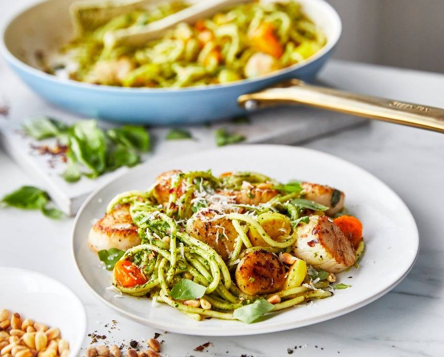 Spaghetti with pesto, scallops and tomatoes sitting on a countertop and made in a GreenPan Reserve Sky Blue 12