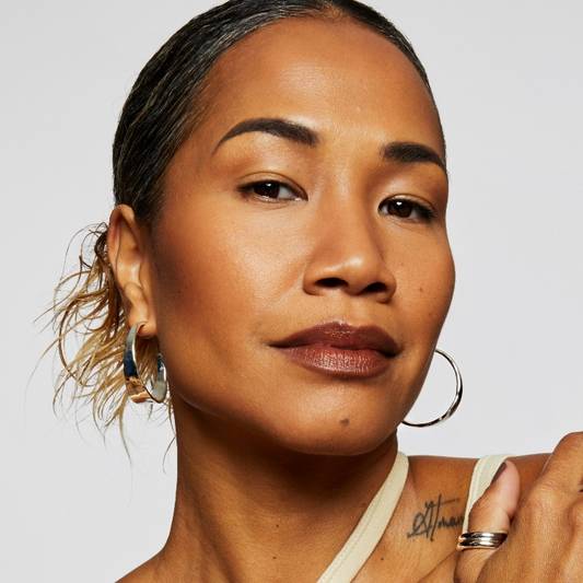Model Brenda wears Milk Makeup Sculpt Stick on white background