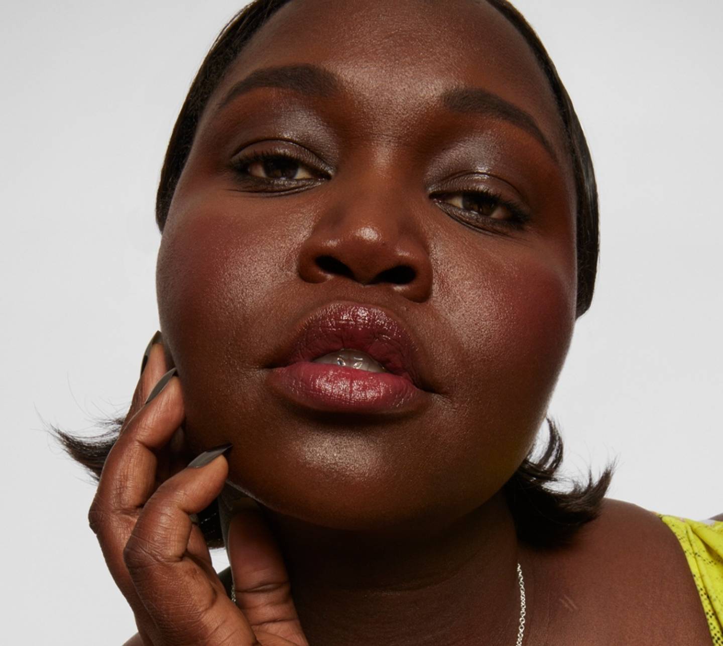 Model wears Milk Makeup KUSH Brow Shadow Stick on white background