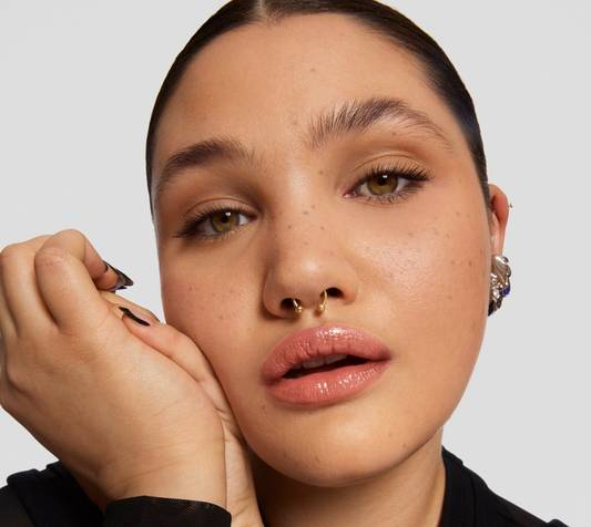 Model with glowy makeup on white background
