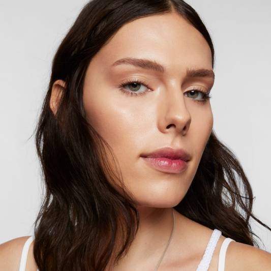 Portrait of Milk Makeup Model Grey against a white background