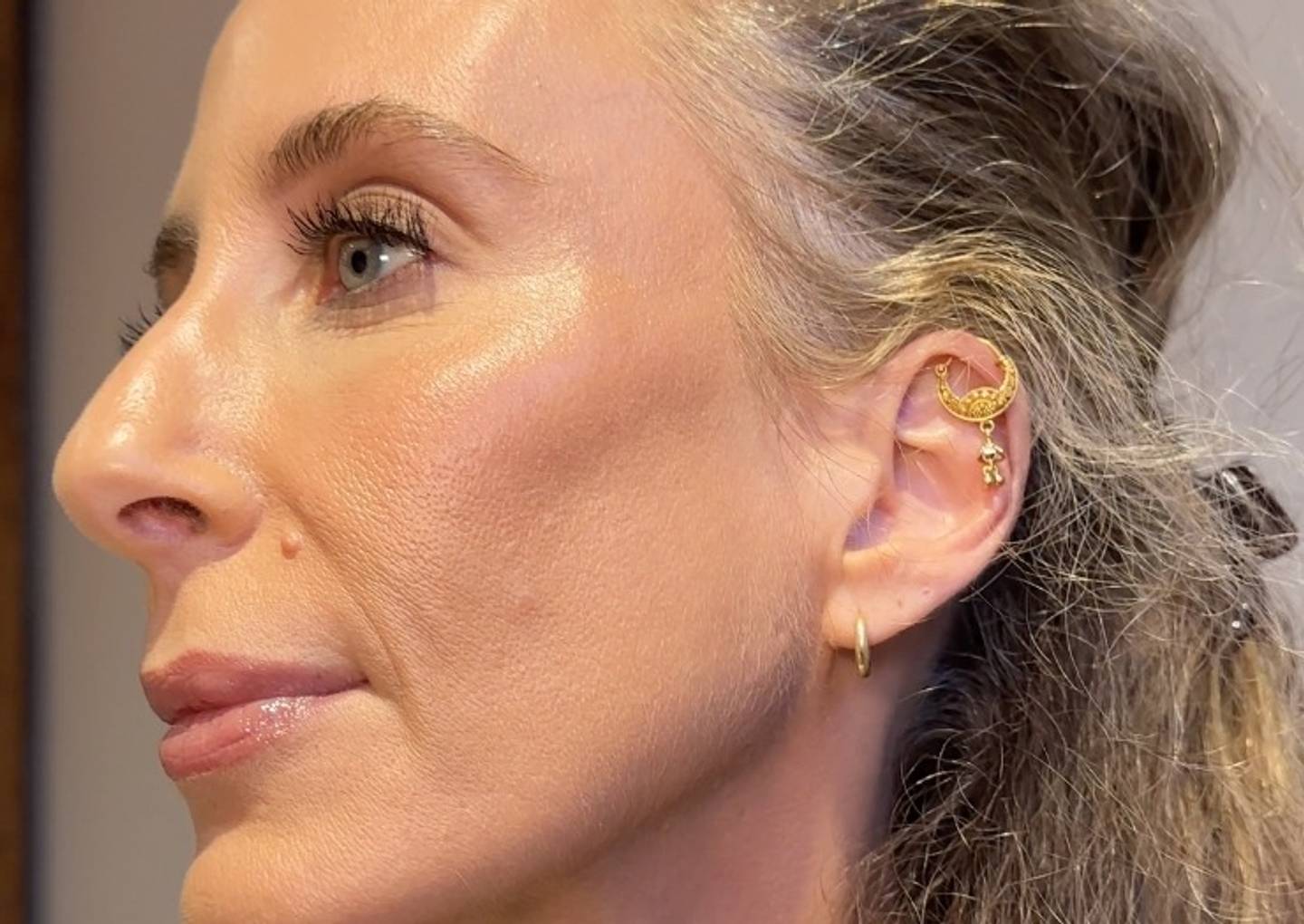 Designer Mara Hoffman wears a full face of Milk Makeup products, showing her side profile.