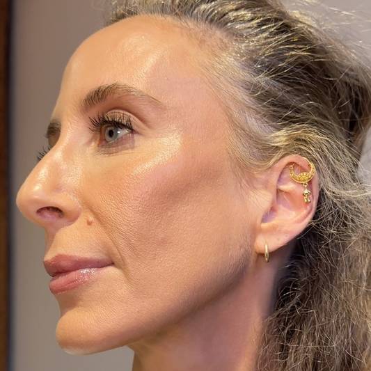 Designer Mara Hoffman wears a full face of Milk Makeup products, showing her side profile.