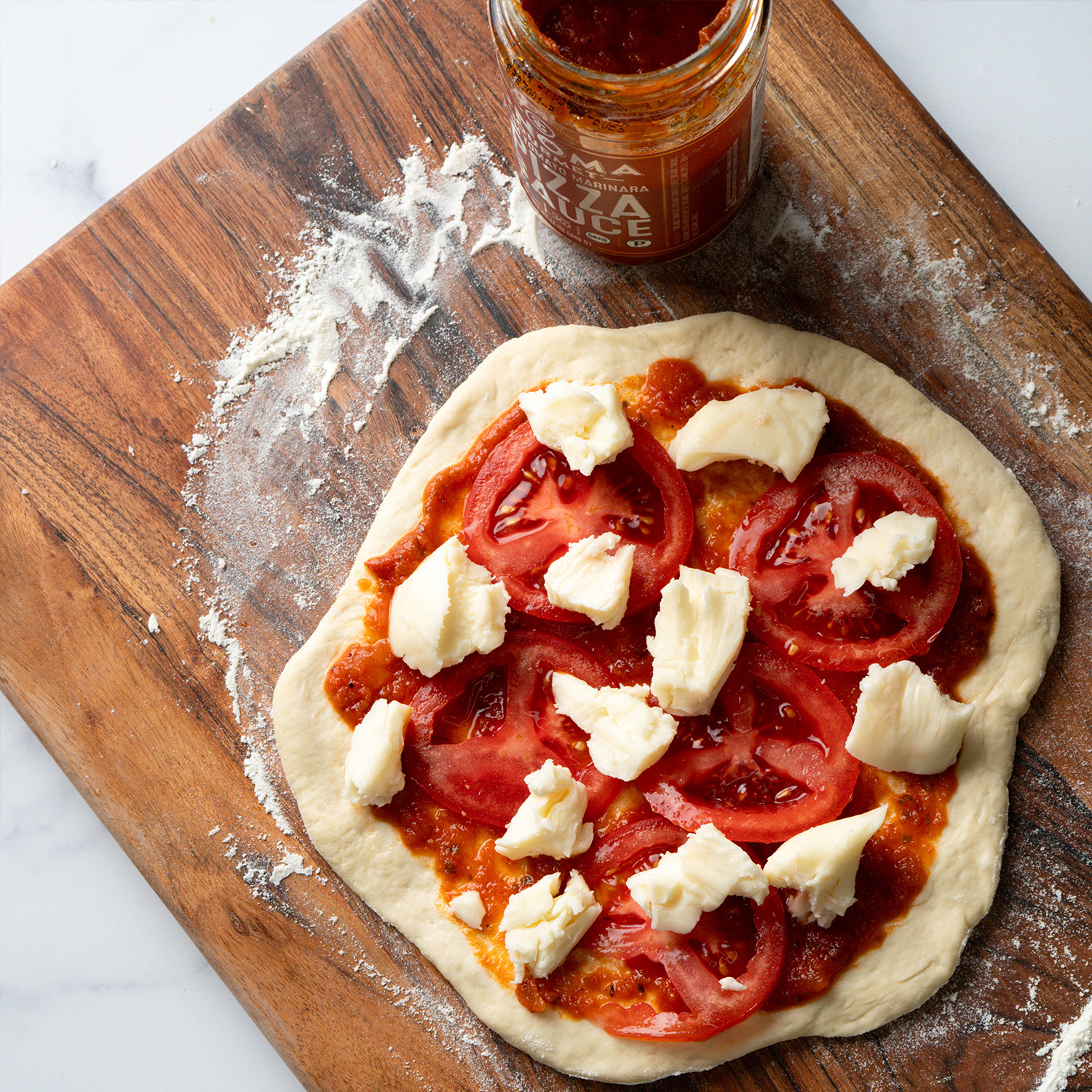 Personal marg pizza made with Sonoma Gourmet's heirloom tomato pizza sauce