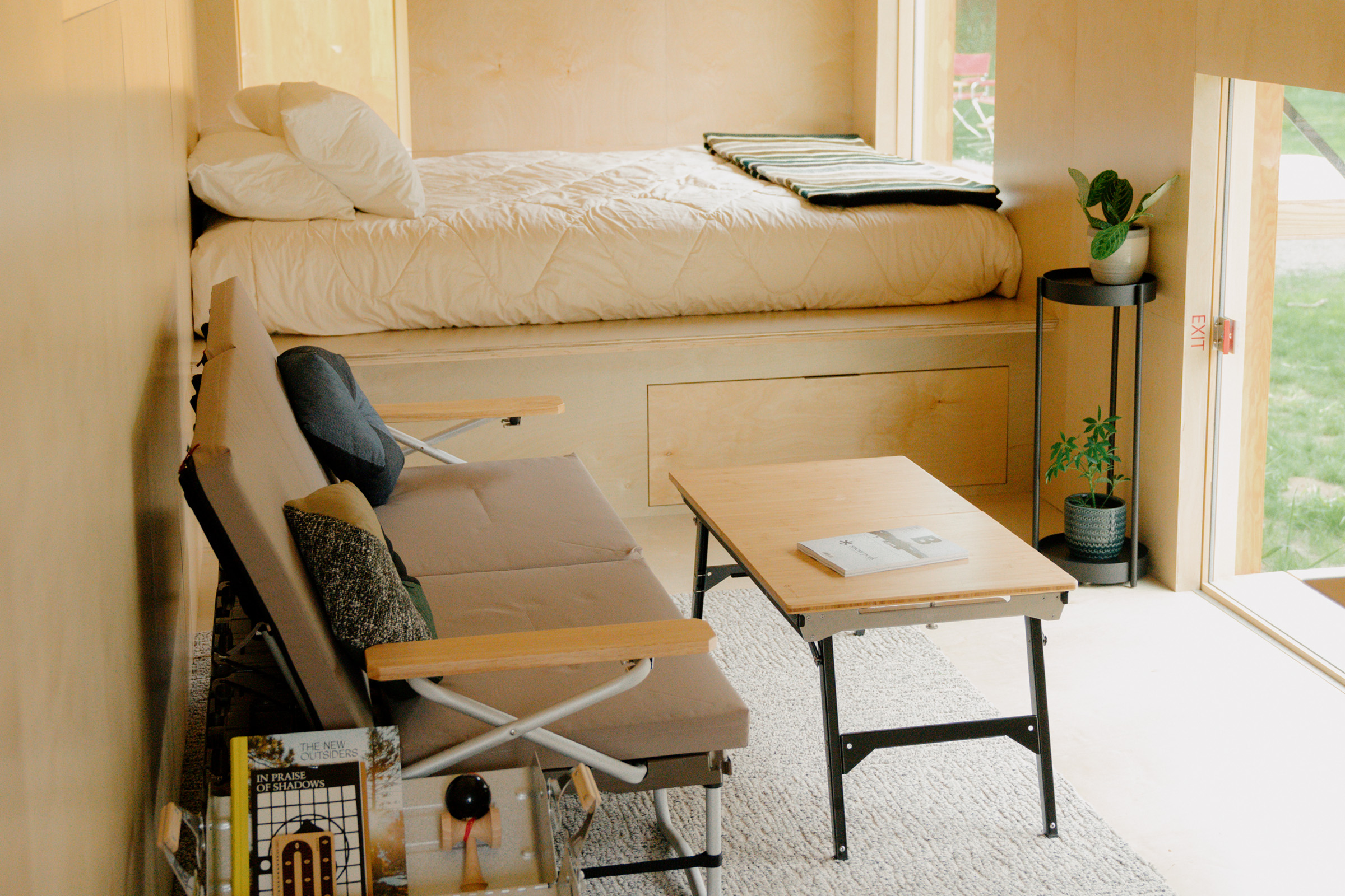 Couch and table next to a bed. 