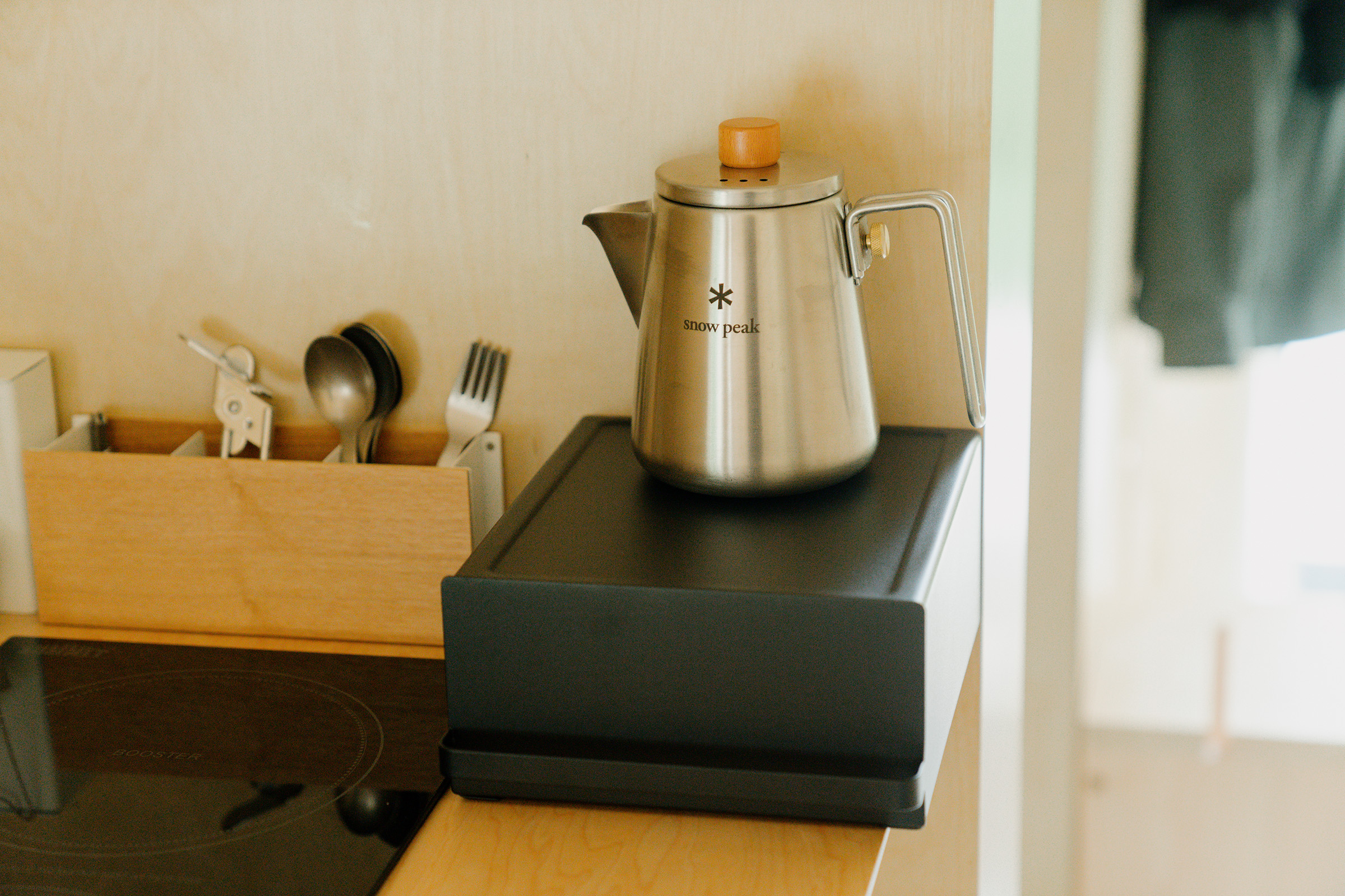 Yamazaki Home Countertop rack with drawer in black with Snow Peak silver kettle. 