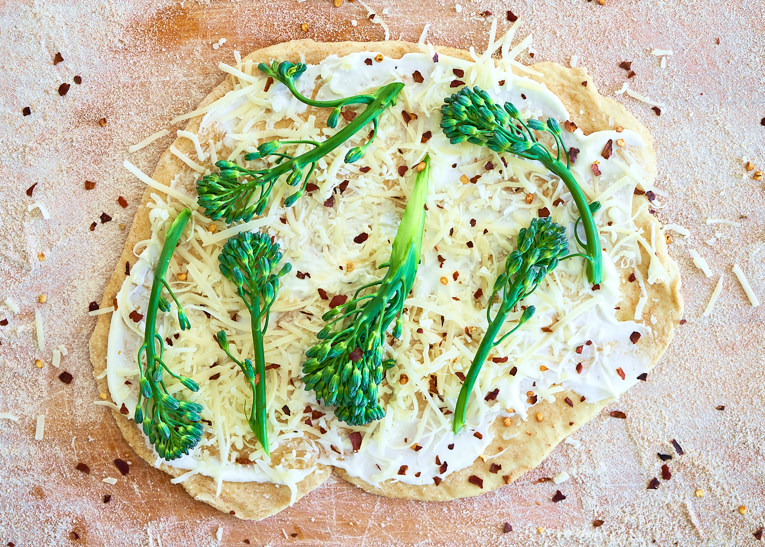White broccolini pizza w/ crème fraîche made with Sonoma Gourmet's proof 100 california extra virgin olive oil