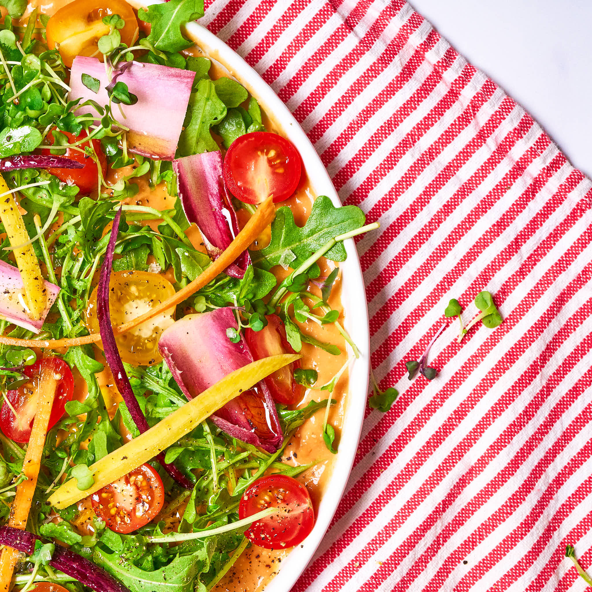 Saucy salad made with Sonoma Gourmet's creamy tomato parmesan and proof 100 california extra virgin olive oil