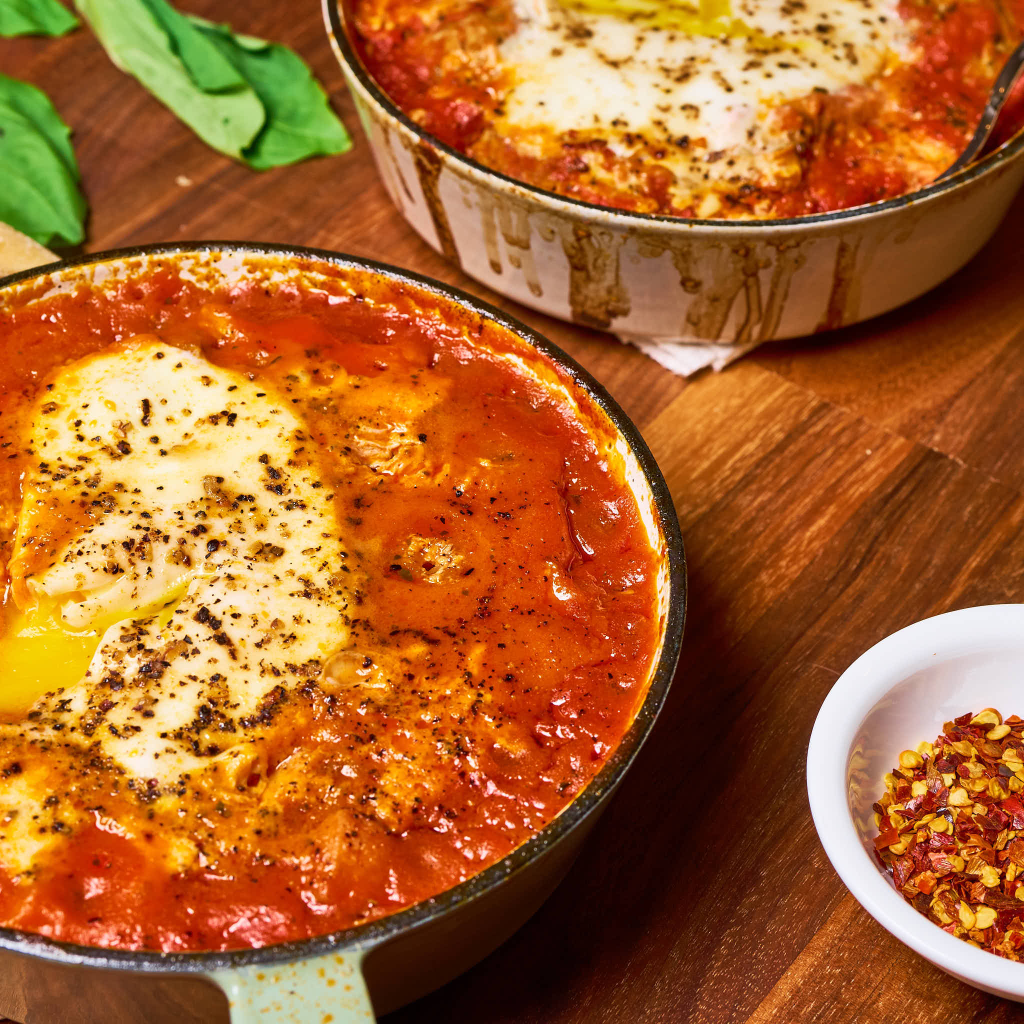 Mini shakshukas made with Sonoma Gourmet's cherry tomato basil sauce and proof 100 california extra virgin olive oil