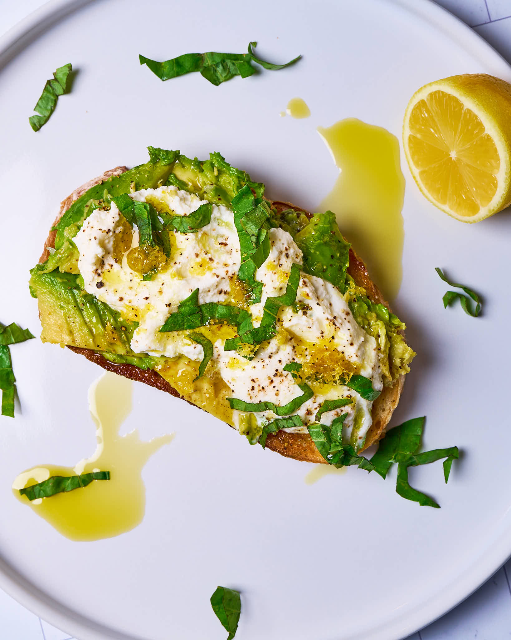Avocado toast with ricotta, lemon zest, and basil made with Sonoma Gourmet's lemon herb olive oil