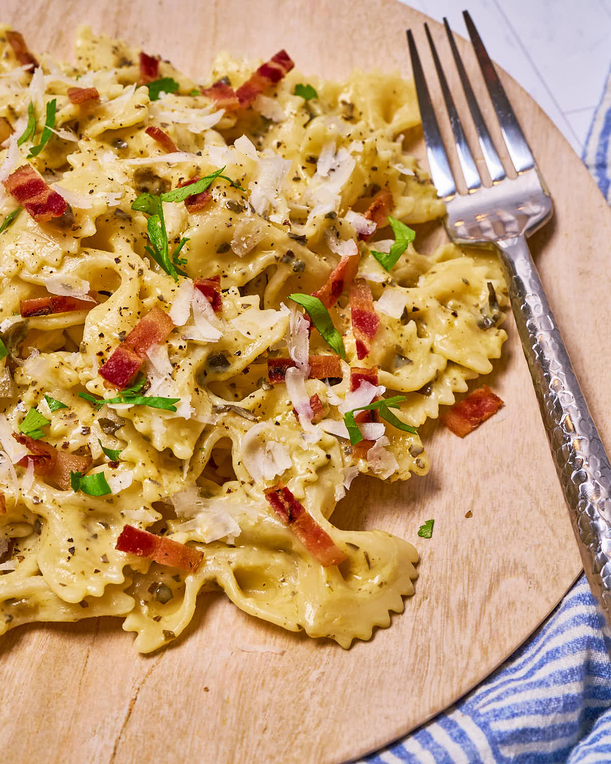 Bow tie pasta with bacon & parmesan made with Sonoma Gourmet's kale pesto white cheddar sauce and proof 100 california extra virgin olive oil