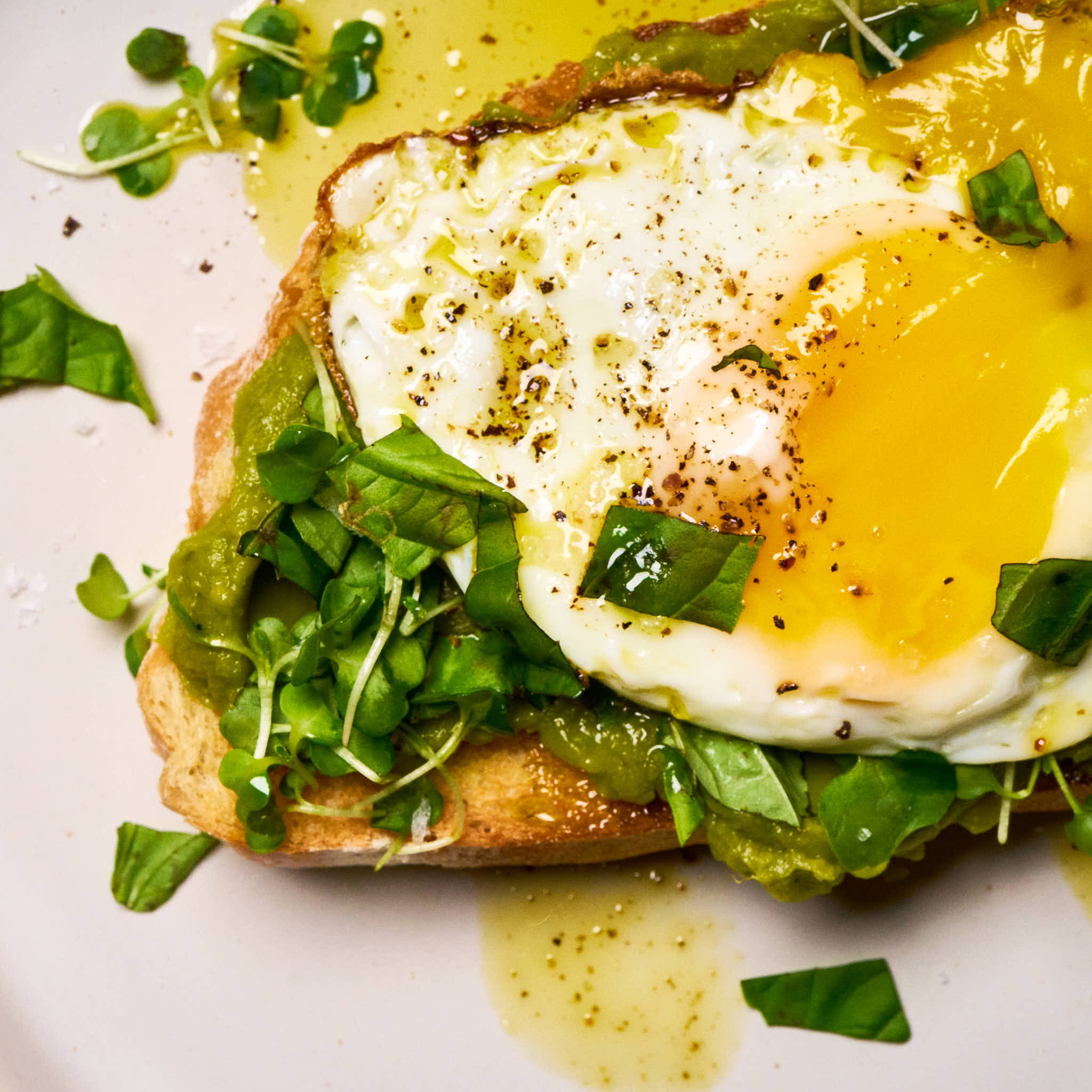 Basil on basil avocado toast made with Sonoma Gourmet's basil parmesan olive oil