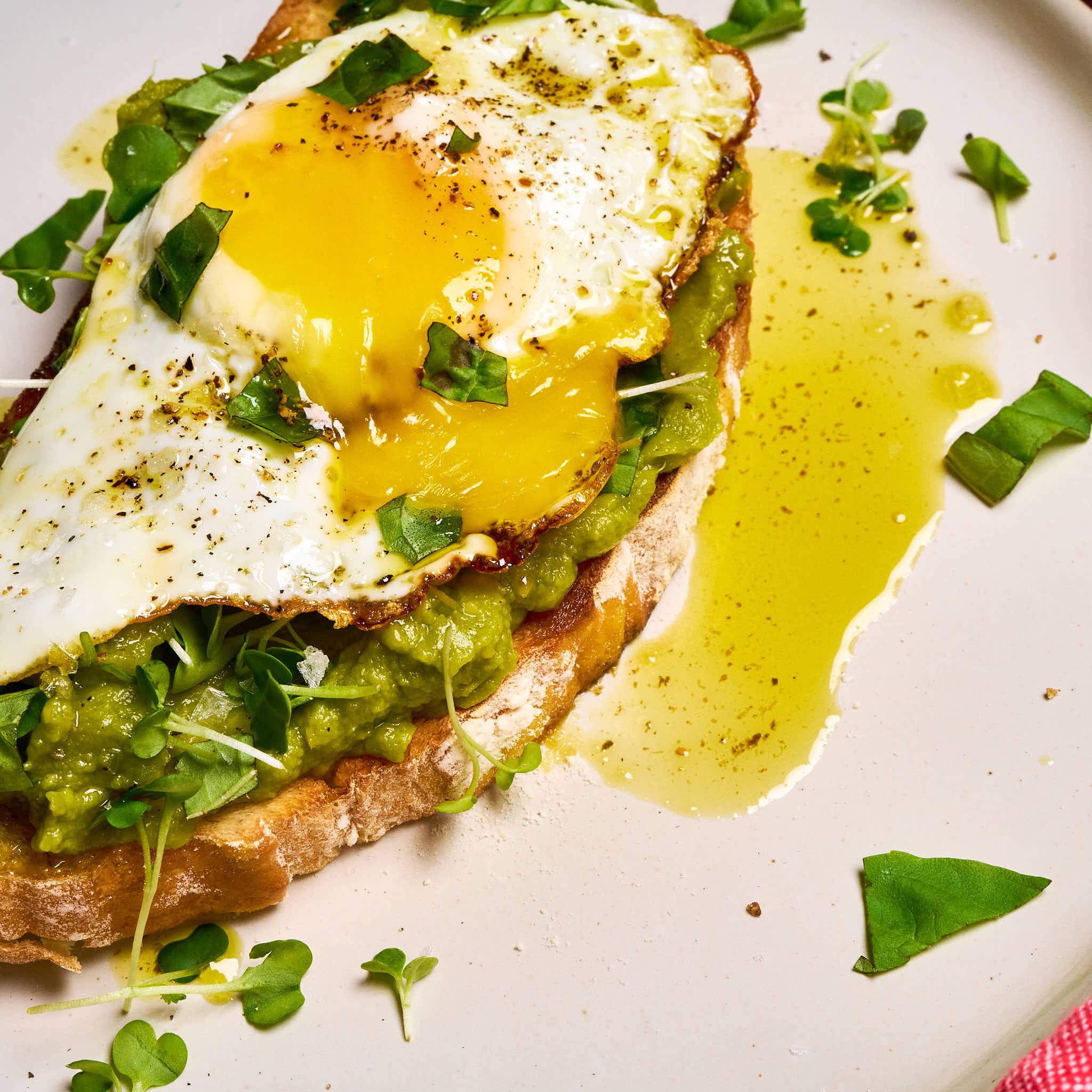 Basil on basil avocado toast made with Sonoma Gourmet's basil parmesan olive oil