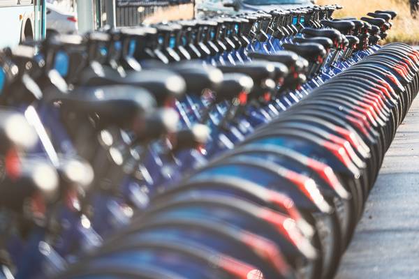 A long row of parked electric bikes for rent in New York