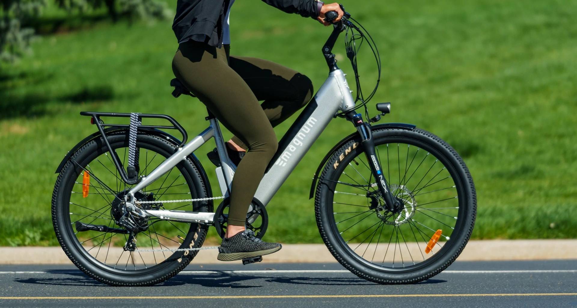 Rider in green pants and sneakers on a white Magnum Cosmo e-bike