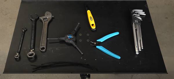 Display of tools needed to change tubes and tires, including side cutters, tire levers, wrenches, and hex keys